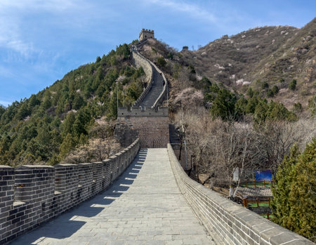 China. Great Wall, Stone path winding up the hill. Staircase and watchtowers, blue sky, sunny dayの写真素材