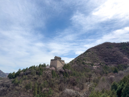 China. Great Wall, Stone watchtoweron rocky mountain landscape, cloudy blue sky,の写真素材