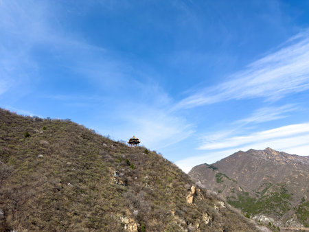 China. Traditional Chinese pavilion on a hillside. Great wall viewpoint. Rocky mountain landscape, blue skyの写真素材