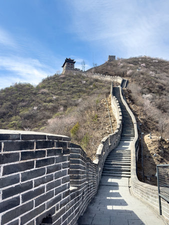 China. Great Wall, Stone path winding up the hill. Staircase and watchtowers, blue sky, sunny dayの写真素材