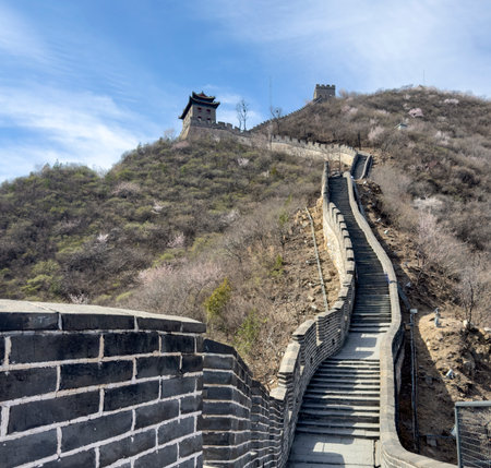 China. Great Wall, Stone path winding up the hill. Staircase and watchtowers, blue sky, sunny dayの写真素材