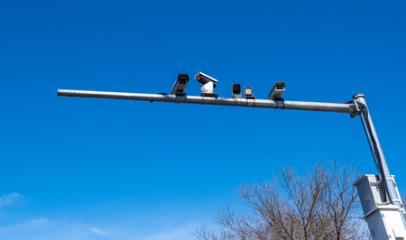 Security cameras over chinese city street, speed monitoring in China, blue sky.の写真素材
