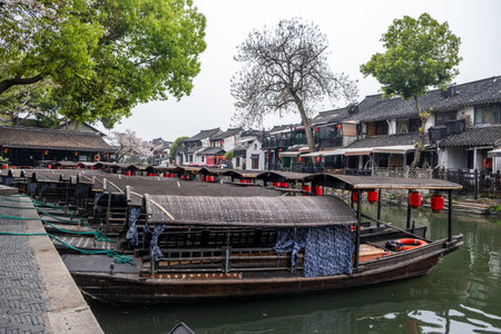 China water town Xitang. Boat on water, traditional chinese architecture buildings on river banksの写真素材