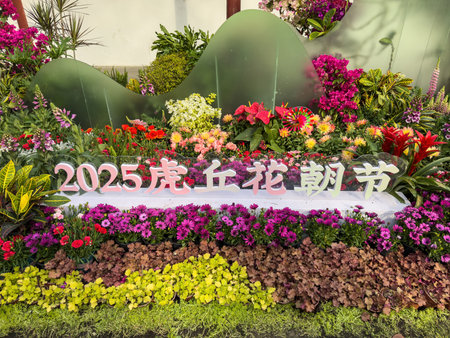 Floral display at the 2025 Huhu Qiu Flower Festival in Suzhou, China. Vibrant layers of colorful flowers with tropical plantsの写真素材