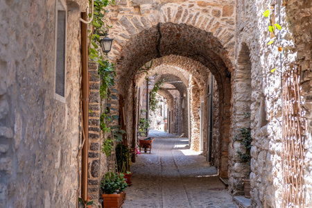 Mesta medieval village, Chios Island, Greece. Narrow alley, stone walls, cobblestone pavement and stone arch. Traditional architectureの写真素材