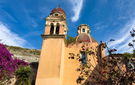 Corfu island old town. Monastery of Panagia Tenedos. Church bell Tower on blue sky, sunny day, Greece.の写真素材