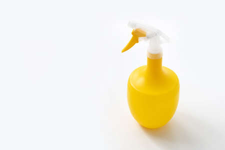 Yellow water sprayer on white background. Home gardening equipment