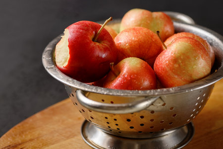 Metallic bowl full of red ripe apples. Healthy eating. Apple pie ingridients. Cooking at homeの写真素材