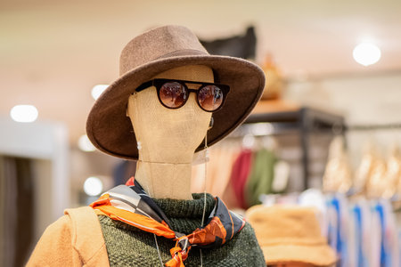 Fashion and Shopping concept. Mannequin dressed in hat and sunglasses in a women's clothing storeの写真素材