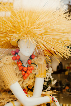 Mannequin wearing Italian pasta dress and decorated with red small tomatoes necklaceの写真素材