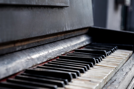 broken black and white keys on ruined piano keyboard close up selective focusの写真素材