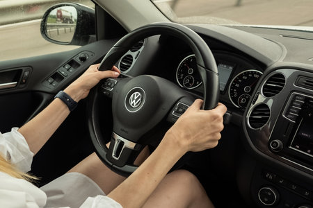 August 2022, Moscow Russia -  woman drives VW Volkswagen car, inside view, steering wheel close up