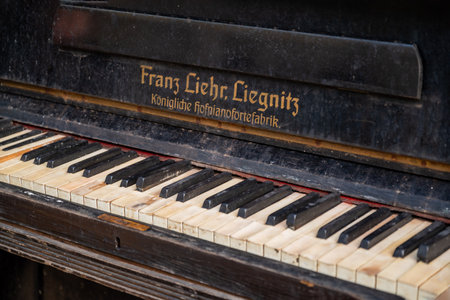 2022 September, Moscow, Russia - ruined piano madee by Franz Liehr Liegnitz weathered keyboard with broken keys close up selective focusのeditorial素材