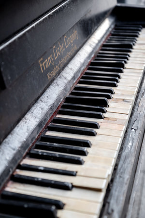 2022 September, Moscow, Russia - ruined piano madee by Franz Liehr Liegnitz weathered keyboard with...