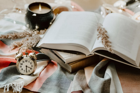 Vintage still life,  open book and alarm clock on the couch