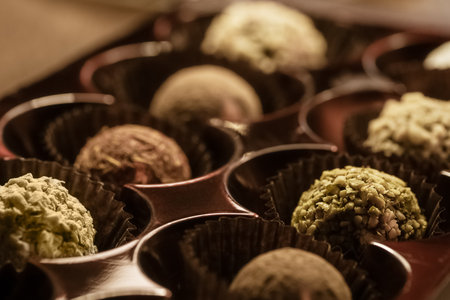 Set of sprinkled chocolates in tray close up, guilty pleasure, sweet foodの写真素材
