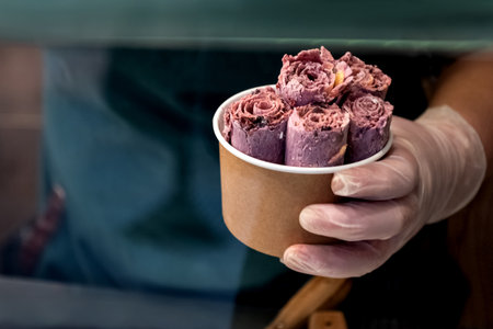 Just cooked pieses of rolled ice cream in paper cupの写真素材