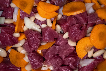 chopped and mixed ingredients for cooking meat stew with vegetablesの写真素材