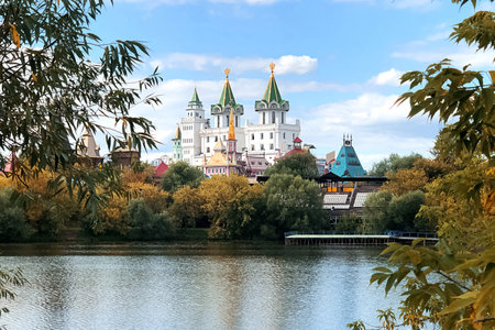 architectural ensemble in the Russian style among the yellowed autumn trees is reflected in the water of the lakeの写真素材