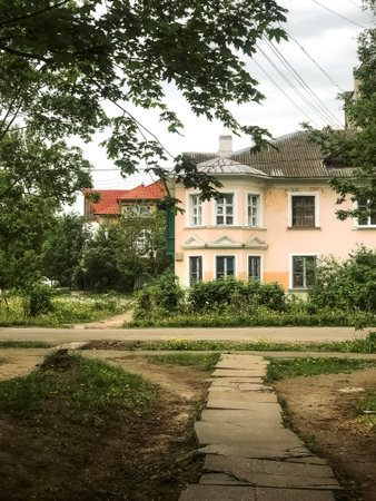 Old two-story house with round bay window among the treesの写真素材