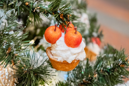Christmas tree branch decorated with cherry pie ornamentの写真素材