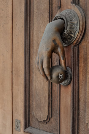 Original design of doorknob looks like woman's hand holding an apple. Knocking on heaven's door conceptの写真素材