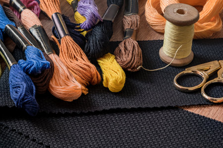 embroidery kit on the table - black canvas, skeins with floss threads and scissorsの写真素材