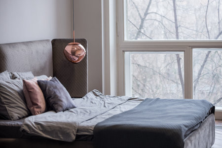 Minimalistic styled bedroom interior  with large windowの写真素材