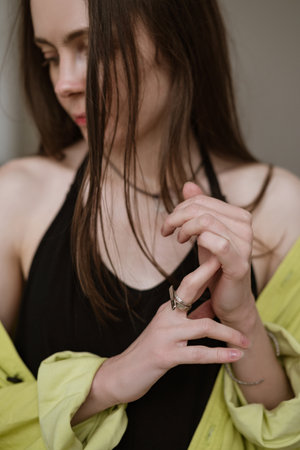 Woman with long dark hair making gesture with her hand.の写真素材