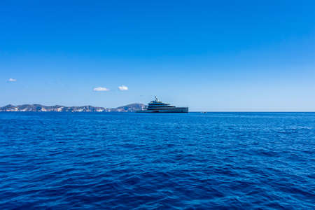 View of the Ponza island with a wonderful luxury yacht in the foreground (Latina, Italy).の写真素材