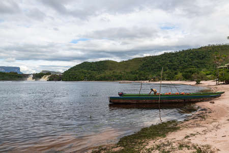 Canaima National Park, Venezuela, 02.11.2021: view of canoes in the lagoon with waterfalls in the background.のeditorial素材