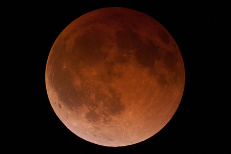 Large full moon takes the form of the Blood Moon against a black night sky