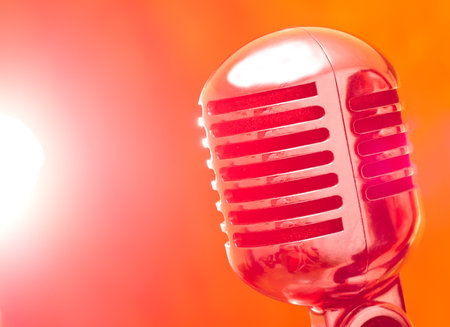 vintage microphone on stage with strobe lightsの写真素材