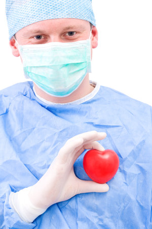 Young doctor with heart in his handの写真素材
