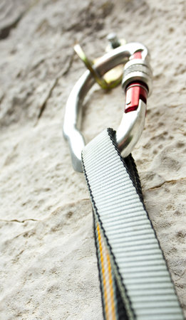 Climbing carabiner on rock wall
