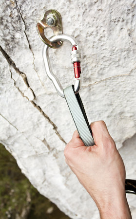Climbing carabiner on rock wallの写真素材