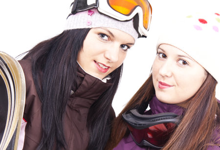 Two beautiful friends getting ready for skiingの写真素材