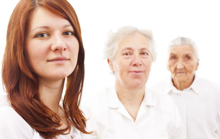 three women from three generations standing in white generations in white standing in fの写真素材