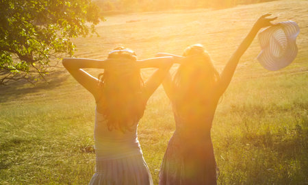 happy girls in the green field の写真素材