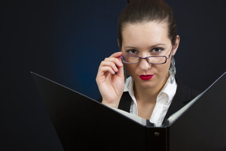 severe businesswoman's portrait with her dossierの写真素材