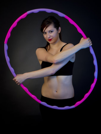 fitness woman playing with hula-hoopの写真素材