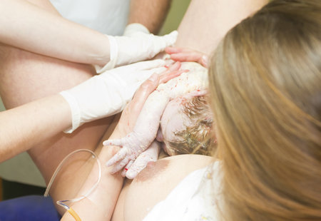 woman giving birth to a baby in a hospitalの写真素材