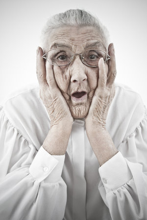 portrait of a surprised old woman who is staring with open mouthの写真素材