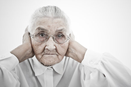 old lady holding her arms to her earsの写真素材