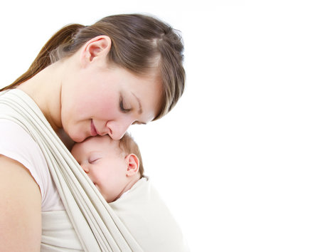 young mother carrying a  newborn sleepimg  babyの写真素材
