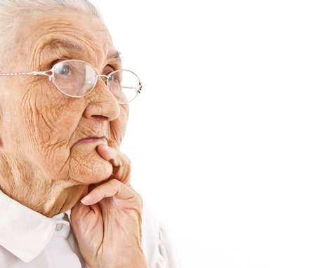 portrait of an old lady contemplating on an isolated backgroundの写真素材