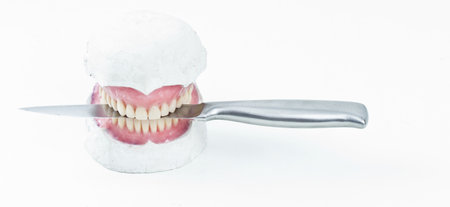 wax denture model with a knifeの写真素材