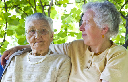old mother and grandmother embracingの写真素材