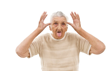 very old woman behaving like a  child on an isolated backgroundの写真素材