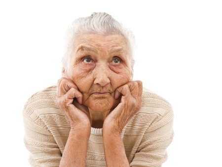 very old lady contemplating on an isolated backgroundの写真素材